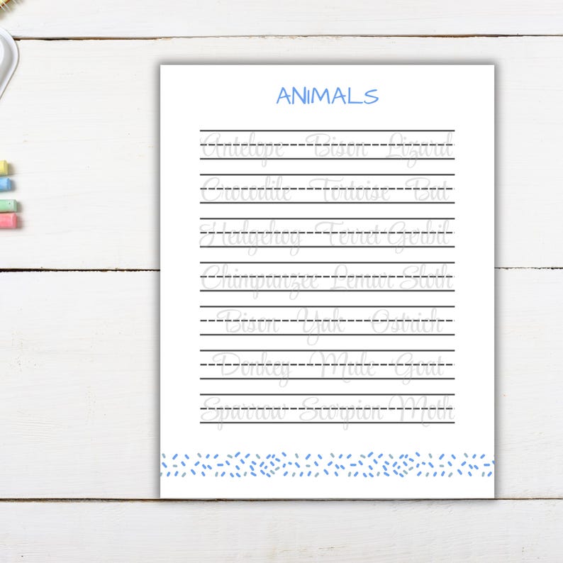 May include: A white educational worksheet titled ANIMALS in blue text, featuring rows of light grey cursive words for tracing. The page includes horizontal lines and a blue dashed pattern at the bottom border, designed for handwriting practice.