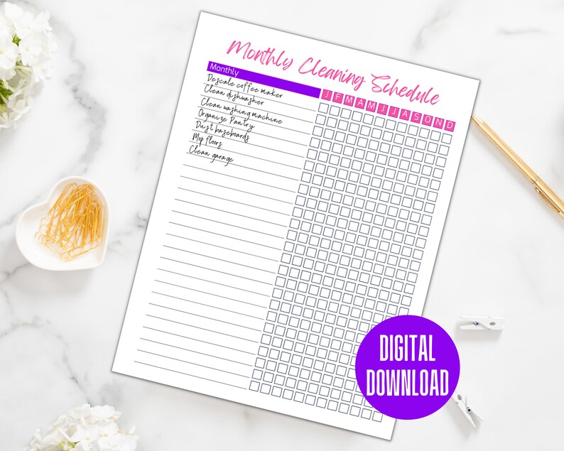May include: A printable monthly cleaning schedule checklist with a purple and pink header. The checklist includes tasks such as descaling the coffee maker, cleaning the dishwasher, and cleaning the garage. The months of the year are listed across the top of the checklist.