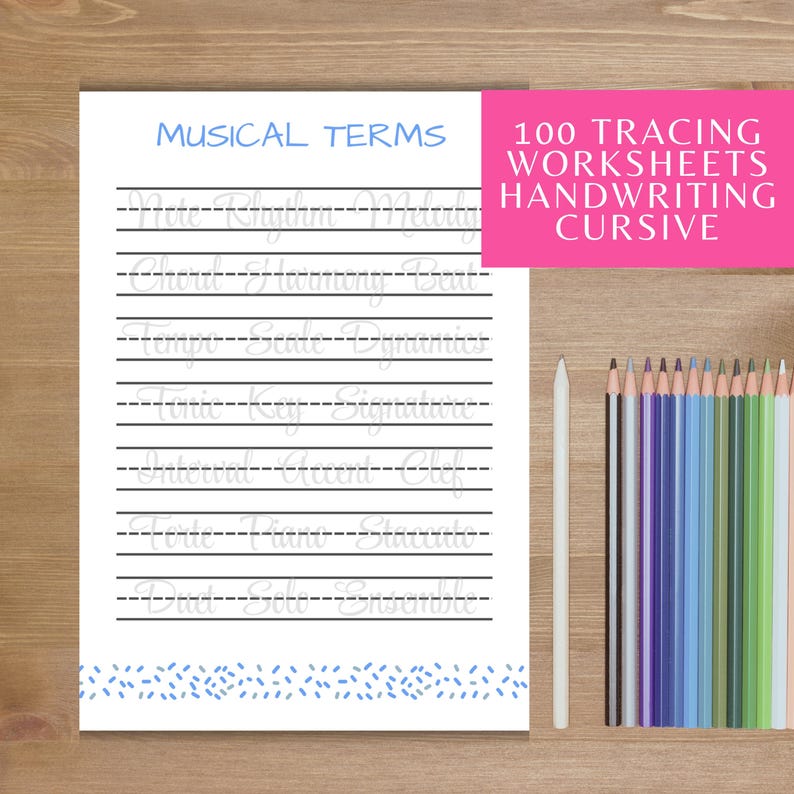 May include: A white paper worksheet titled MUSICAL TERMS with light grey cursive text for tracing on black horizontal lines. A bright pink box displays 100 TRACING WORKSHEETS HANDWRITING CURSIVE. A white pencil and a row of coloured pencils are included.