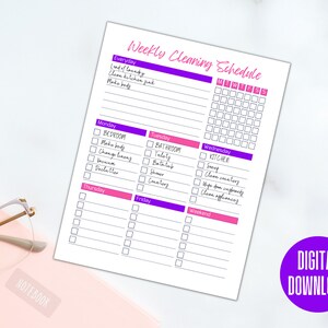 May include: A printable weekly cleaning schedule checklist with a pink and purple color scheme. The checklist includes daily, weekly, and weekend tasks. The days of the week are listed across the top, and the tasks are listed in columns below each day. The tasks include making the bed, doing laundry, cleaning the kitchen, cleaning the bathroom, and cleaning the kitchen.