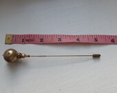 Stickpin or hatpin, brass, art nouveau style with star pattern