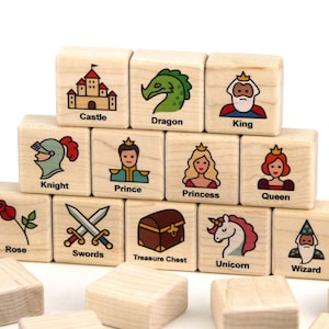May include: A set of wooden blocks with illustrations of various fairy tale characters and objects, including a knight, a prince, a princess, a queen, a dragon, a castle, a treasure chest, a unicorn, a wizard, swords, and a rose.