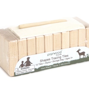 May include: A set of 10 wooden shape tracing tiles in a clear plastic bag with a wooden stylus. The packaging includes the text "everwood friends Shapes Tracing Tiles 10 Tiles + Stylus Storage Bag Ages 3+ Hard Maple Made in Minnesota".