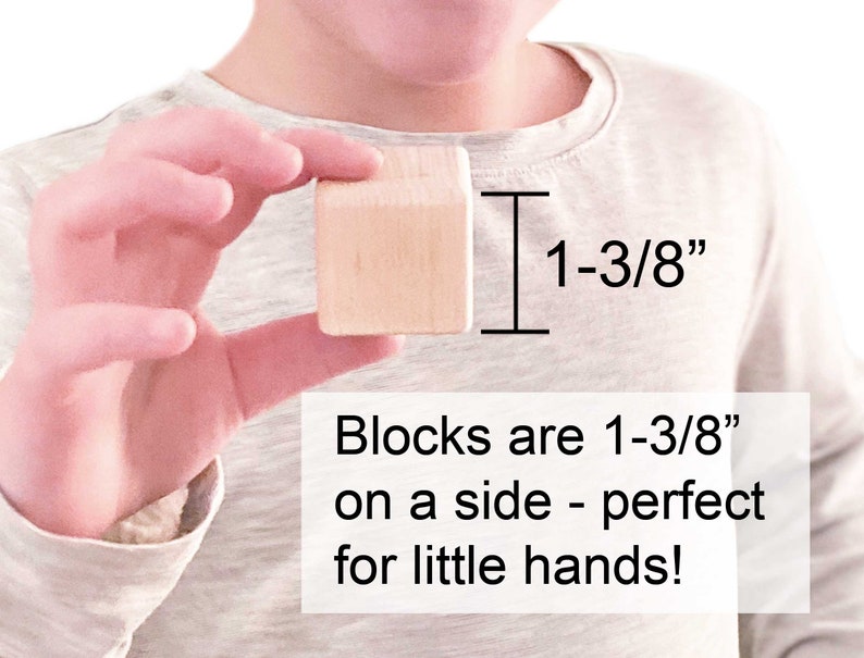 May include: A light-colored wooden cube block measuring 1-3/8 inches on each side. The image includes text stating: Blocks are 1-3/8 inches on a side - perfect for little hands! The block has a smooth, unfinished surface with visible wood grain.