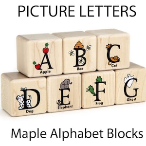 May include: Wooden alphabet blocks with letters A through G, each featuring a corresponding image and word. The blocks are made of light-colored wood and are labeled "Picture Letters" and "Maple Alphabet Blocks".