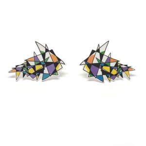May include: A pair of earrings with a geometric design featuring a variety of colors, including purple, yellow, orange, and blue.