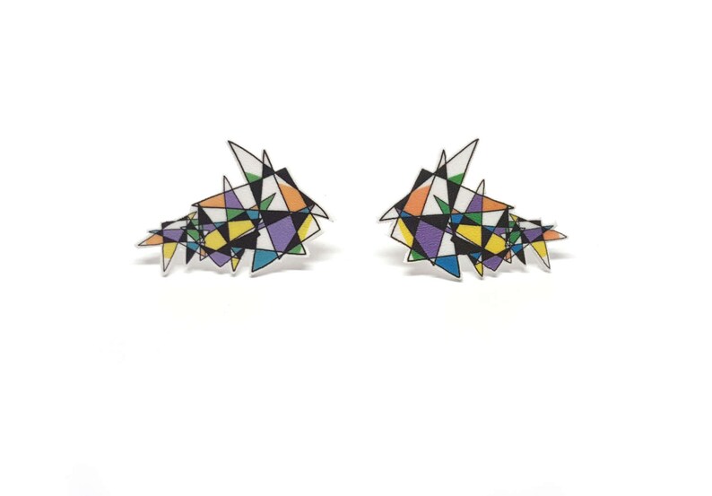 May include: A pair of earrings with a geometric design featuring a variety of colors, including purple, yellow, orange, and blue.