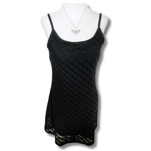 May include: A black sleeveless dress with a delicate crochet pattern. The dress has a fitted bodice and a flowing skirt.