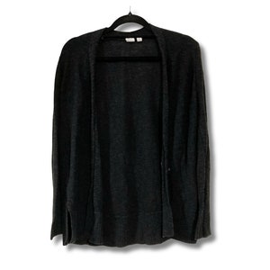 May include: A dark gray cardigan with long sleeves and a v-neck. The cardigan is hanging on a black hanger.