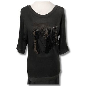 May include: A black, long-sleeved shirt with a sequined design of two owls on the front.