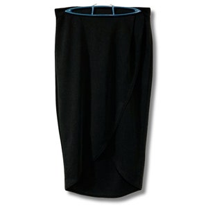 May include: A black wrap skirt with a high waist and a slightly asymmetrical hemline.
