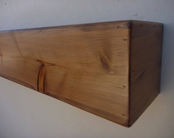 May include: A natural wood shelf with a light brown stain. The shelf is made of solid wood and has a rustic look.