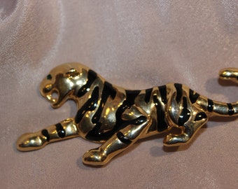 Amazing tiger brooch with green rhinestone eye.