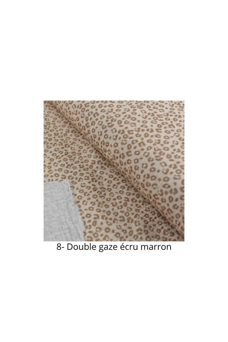 May include: Close-up of a beige fabric with a brown leopard print. The fabric is folded in half and the text "8- Double gaze ecru marron" is visible at the bottom of the image.