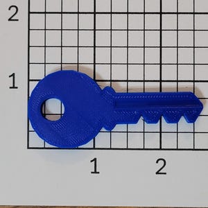 May include: A blue plastic key with a round head and a serrated edge. The key is about 2 inches long.