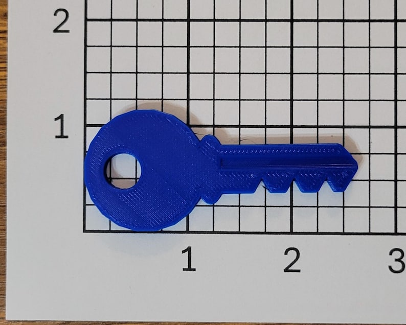 May include: A blue plastic key with a round head and a serrated edge. The key is about 2 inches long.