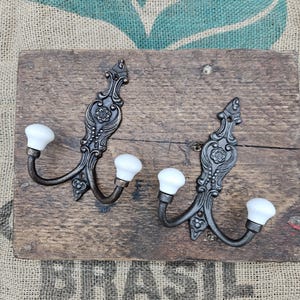 The French Style Double Robe cast iron hook with an Antique Iron or Antique Copper finish and Hook with Ivory ceramic ball tips