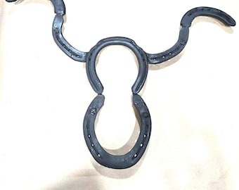 Authentic horseshoes repurposed into a Longhorn wall hanging - Mat Black and Original Rustic finish available.
