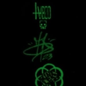 May include: A green glow-in-the-dark sticker with a skull, the word "HBO", a stylized "$B", and a circular design.