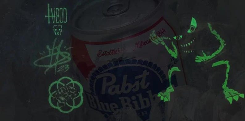 May include: A green glow-in-the-dark sticker of a monster with a single eye and sharp teeth. The sticker is placed on a can of Pabst Blue Ribbon beer. The can is silver with a red and blue label. The text "Established Milwaukee 1844" is visible on the label.
