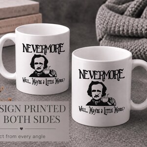 May include: Two white ceramic mugs featuring a black graphic illustration of Edgar Allan Poe holding a teacup. The text NEVERMORE is printed above the portrait, and the text Well... Maybe a little more? is printed below the illustration.