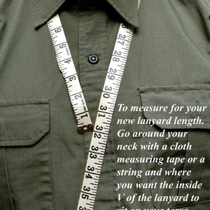 May include: An olive green shirt with a white measuring tape draped around the collar. The tape shows measurements in inches. Text on the image provides instructions on measuring for a lanyard.
