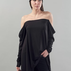 May include: A black off-the-shoulder top with long sleeves and a draped design. The top is made of a soft, stretchy fabric.