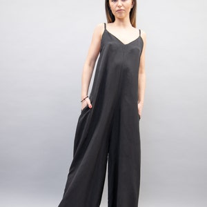 May include: A black sleeveless jumpsuit with a wide leg and a V-neckline.