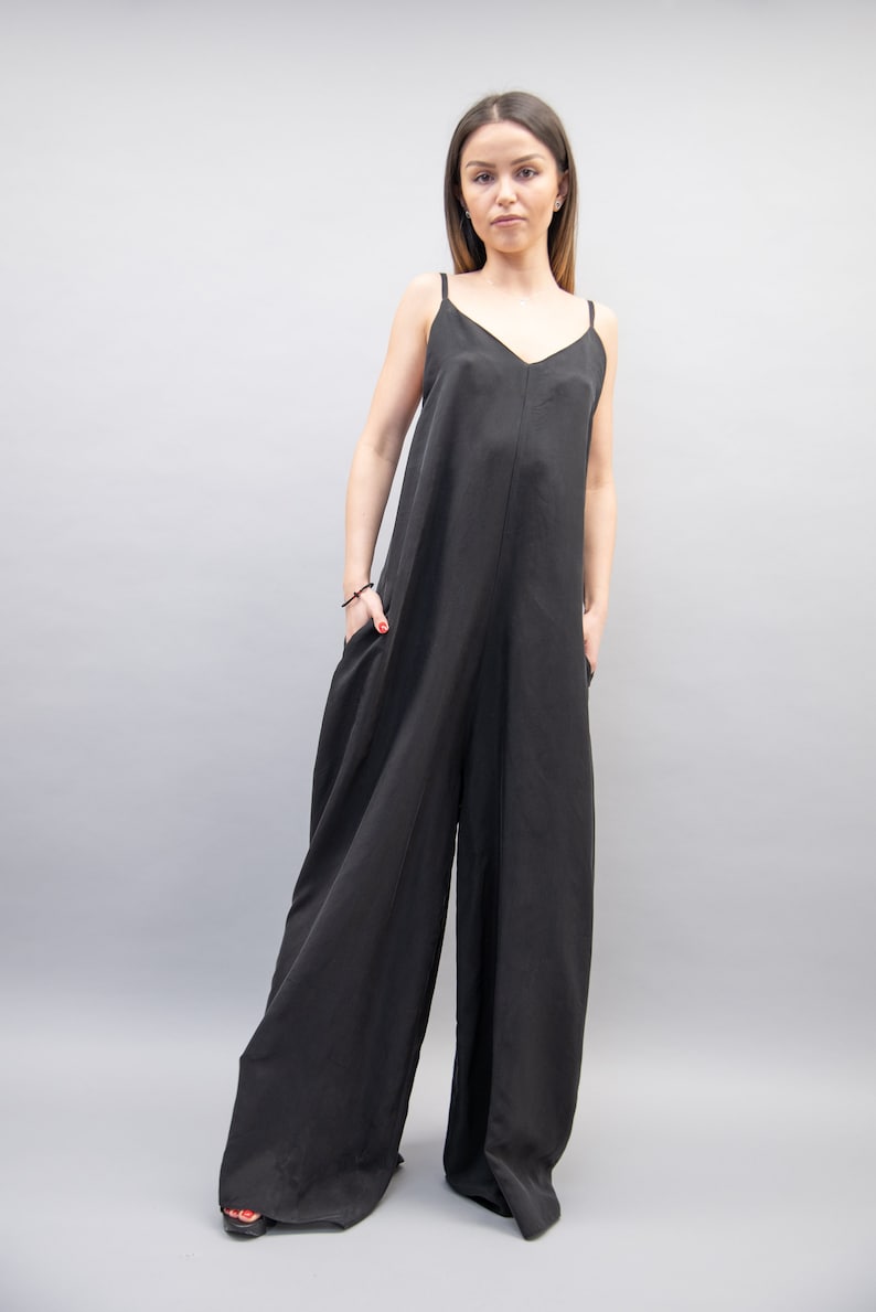 May include: A black sleeveless jumpsuit with a wide leg and a V-neckline.