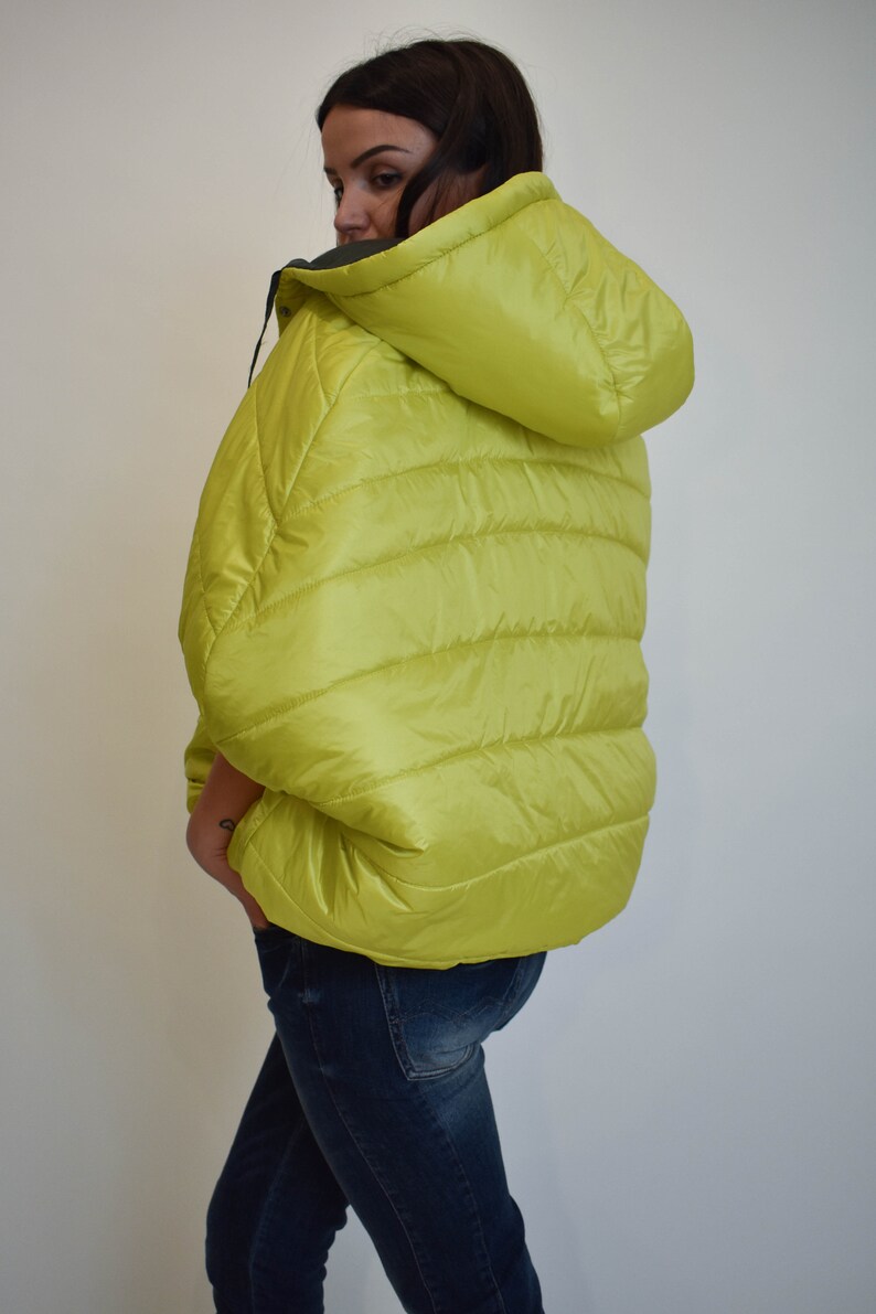 May include: A lime green puffer jacket with a hood. The jacket has a quilted design and is made of a lightweight material.