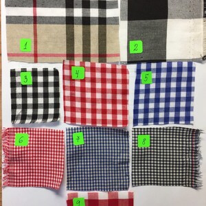 May include: Nine fabric swatches with various plaid patterns. The swatches are numbered 1 through 9. The swatches are arranged in three rows of three. The swatches are all different colours and patterns.