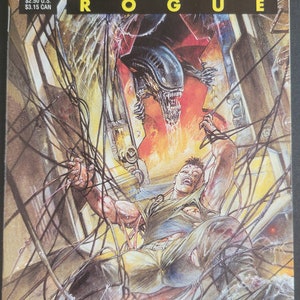 May include: A comic book cover featuring an illustration of an alien creature with sharp teeth and a human character trapped in a web of wires. The title of the comic is "Aliens Rogue" and the issue number is 1 of 4. The comic is published by Dark Horse Comics.