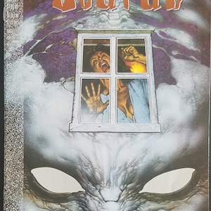 May include: A comic book cover with a dark, textured background. The title "Scarab" is written in large, orange letters. A woman is seen screaming from a window, with a monstrous creature lurking in the shadows below. The text "John Smith, Scot Eaton, Mike Barreiro" is printed at the bottom of the cover.