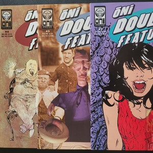 May include: Four comic books with colorful covers. The first three are titled "Oni Double Feature" and feature a variety of characters. The fourth comic book is titled "Oni Double Feature" and features a woman with long black hair and a red shirt.