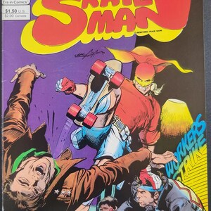May include: A comic book titled Skateman Issue #1 by Neal Adams featuring a character in a red shirt, yellow mask, and roller skates performing a jump. The cover art includes the text Skateman, Neal Adams, and Workers Strike in bold lettering.