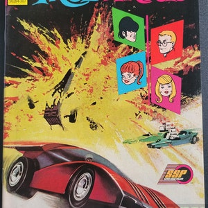 May include: A comic book cover featuring a red and black futuristic car speeding through a yellow and orange explosion. The cover title is "Mod Wheels" and the text reads "Wheels can't compete with a rival - who races to win or die in the attempt!"
