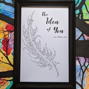 May include: A framed print with a black frame and a white background. The print features a black and white stylized image of a flame with the words "The Idea of You" and "Dave Matthews Band" written in black.