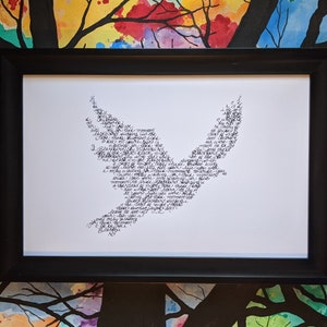 May include: A black framed print with a white background featuring a stylized bird shape made up of words in black ink.