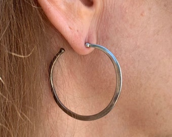 Silver Hoop Earrings: Silversmith  craftsman sterling silver earrings  in asymmetrical dramatic shape on posts with stamped 925.  80’s 11679