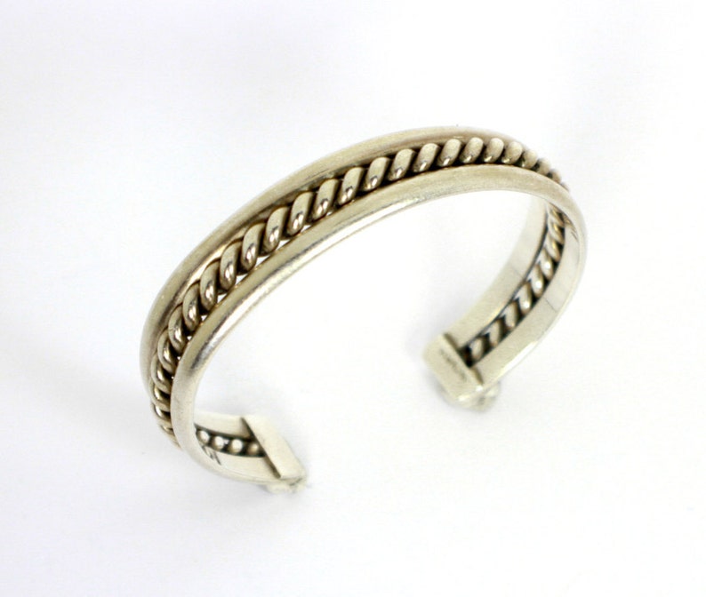 Silver cuff style Native American Bracelet with heavily braided silver rope in the center of two silver bands Sterling Silver 925 0471