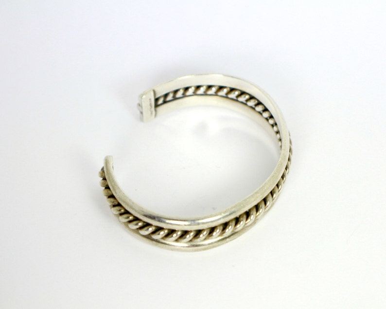 Silver cuff style Native American Bracelet with heavily braided silver rope in the center of two silver bands Sterling Silver 925 0471
