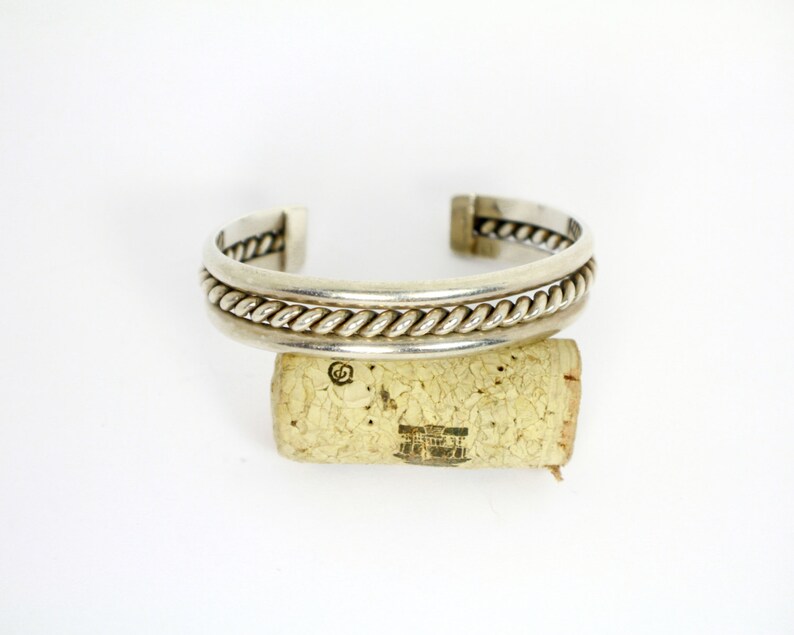 Silver cuff style Native American Bracelet with heavily braided silver rope in the center of two silver bands Sterling Silver 925 0471