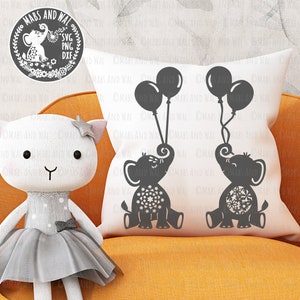 May include: Two black silhouette elephants holding balloons, one elephant has a floral pattern and the other has a star pattern. The elephants are on a white cushion with the text "MABS AND WAL" repeated on the cushion.