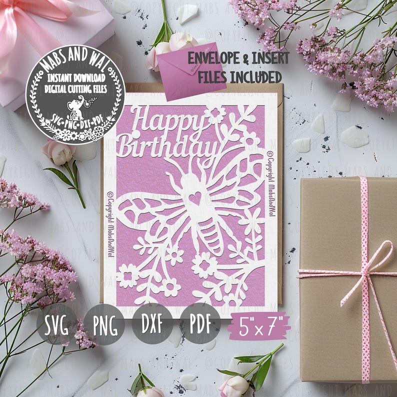 Pode incluir: Um cart&atilde;o rosa com um design de borboleta branca e flores. O cart&atilde;o diz "Feliz anivers&aacute;rio" e mede 12,7 cm por 17,8 cm. O cart&atilde;o est&aacute; rodeado de flores rosas e um pacote castanho com uma fita rosa.