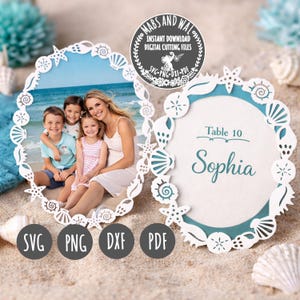 May include: Two seashell-themed photo frames and place cards on a sandy beach. One frame holds a family photo, while the other displays "Table 10" and the name "Sophia." The frames are white with intricate cut-out designs. The image includes the text "MABS AND WAI" and "INSTANT DOWNLOAD DIGITAL CUTTING FILES."