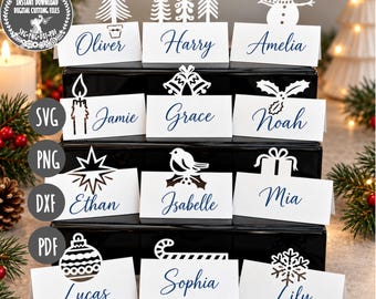 May include: A set of white folded place cards with dark blue script names and various die-cut Christmas toppers including a snowman, trees, bells, holly, a star, a bird, a gift, an ornament, a candy cane, and a snowflake on a black stand.