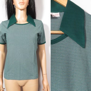 May include: Green and white striped short-sleeved shirt with a green collar. The collar is a contrasting colour to the shirt.