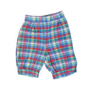 May include: Red, blue, and green plaid shorts with an elastic waistband.