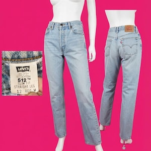 May include: Light blue denim jeans with a slim fit and straight leg cut. The interior tag displays Levi's 512 Slim Fit Straight Leg 12 Reg M. The back features a tan leather patch and a small red tab on the pocket. The jeans are shown from front and back.