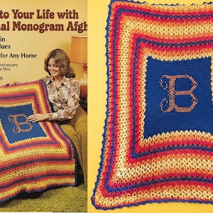 May include: A rectangular crochet afghan blanket featuring a central dark blue square with a large orange letter B monogram. The border consists of concentric stripes in yellow, orange, red, and dark blue, finished with a decorative scalloped edge.